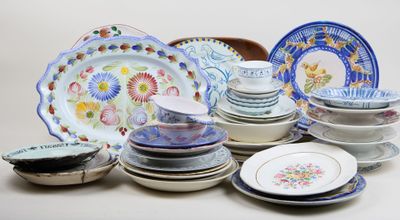 a lot of plates and bowls sitting on a table