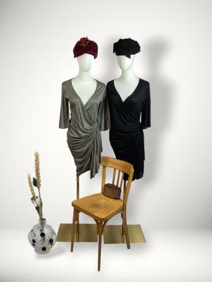 two mannequins that are standing next to a chair