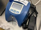un appareil bleu et blanc posé sur un comptoir à côté d'un téléphone portable