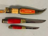 three different types of knives on a white surface