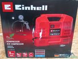 a box of a red air compressor sitting on top of a table
