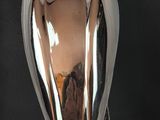 a silver statue of an angel on a black background