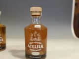 three bottles of alcohol sitting on a table