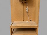 a wooden chair with a shelf and a lamp on it