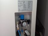 a picture of a water heater with a hose connected to it