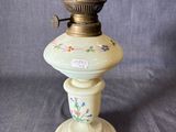 une lampe à huile à l'ancienne surmontée d'un oiseau