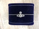 a close up of a blue velvet box with a silver bracelet on it