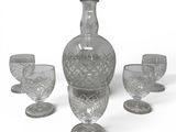 bottles and glasses on a white surface with a white background