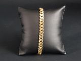 a black pillow with a gold chain on it