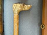 two old walking canes and a walking stick on a table