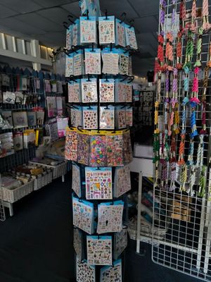 a tall tower of cards in a store with a lot of cards on it