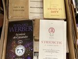 many books in a cardboard box on the floor