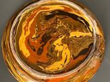 a close up of a glass with a liquid inside of it