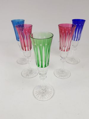 four wine glasses sitting next to each other on a table
