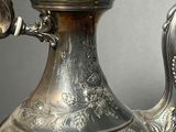 a silver tea pot that is sitting on a table