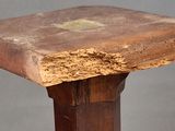 a wooden table with a square top on a gray background