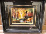 framed oil painting of a stream in a wooded setting