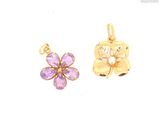 two gold - plated charms with a flower and a butterfly
