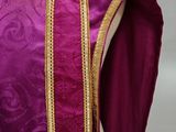 a close up of a purple and gold dress on a mannequin