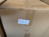 a cardboard box with a sticker on it sitting on the floor