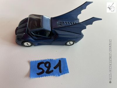 une petite voiture bleue sur laquelle est posé une chauve-souris