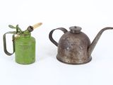two old teapots sitting next to each other on a white surface