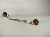 two brass pipe heads on a white surface with a white background