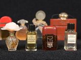 many different types of perfume bottles lined up in a row