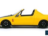 a yellow toy car that is sitting on a white surface