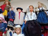 a lot of dolls in a box on the floor