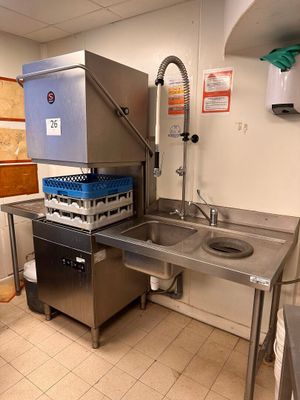 a kitchen with a sink and a refrigerator in it