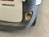 a small white van parked in a parking lot