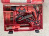 a red tool box with tools in it on the floor