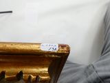 une photo d'une personne assise sur un canapé, tenant une télécommande
