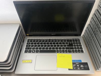 a laptop computer sitting on top of a stack of books