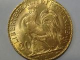 a close up of a gold coin with a rooster on it