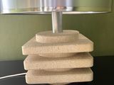 a table with a lamp and a stack of sponges on it