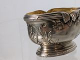 a silver bowl that is sitting on a glass table