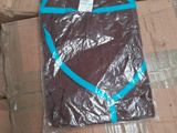 many boxes of clothing wrapped in plastic on the floor