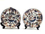 pair of blue and white plates with floral designs on them