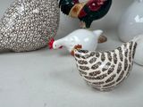 a lot of ceramic birds that are sitting on a table