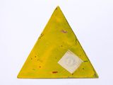 a yellow triangle shaped object with a tag on it