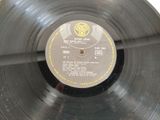 a black record with a yellow label on it