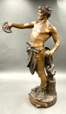 bronze statue of a man holding a bird in his hand