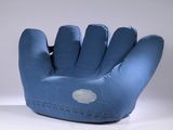 a blue baseball glove that is sitting on a table