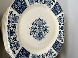 several blue and white plates are stacked on top of each other