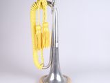 a silver trumpet with a yellow rope on top of it