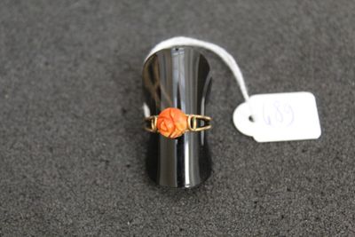 a ring with a flower on it sitting on a table