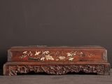 an old wooden box sitting on top of a table next to a wall
