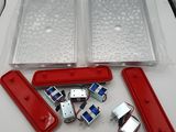 the contents of a red and white table with a pair of scissors and a pair of screws